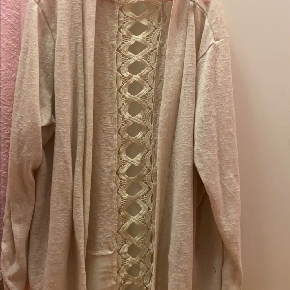 Beige cardigan with design in back.